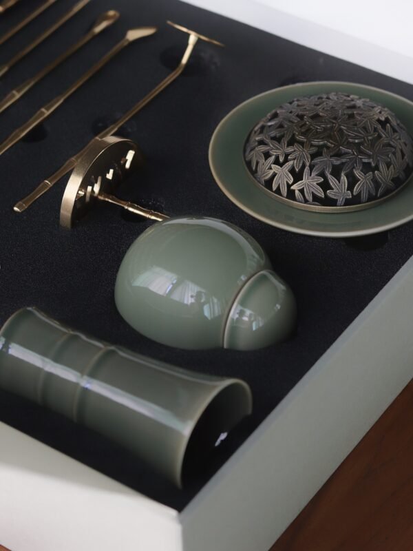 Yue Kiln Celadon incense tools set page, featuring a celadon incense burner, gold tools, and scented bottle in a black box, designed for traditional Chinese herbal incense practices on a wooden table.