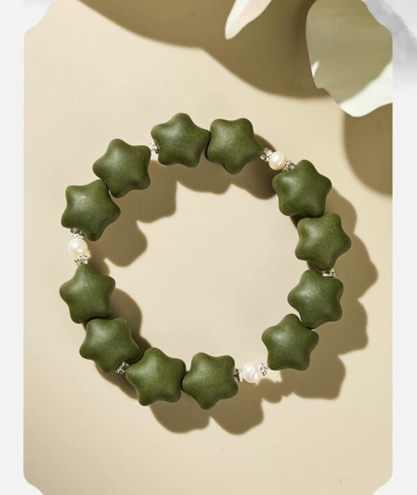 Green star-shaped bead bracelet with white accents.