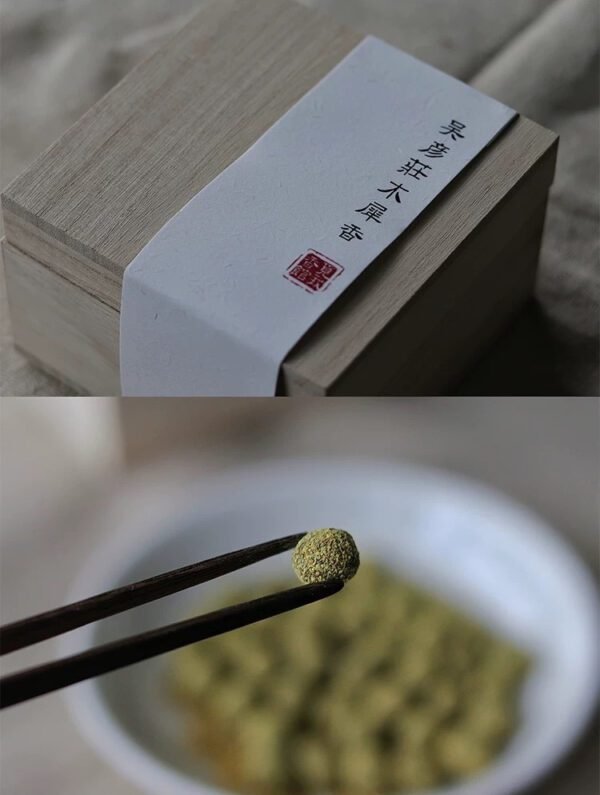 Herbal incense in a wooden box with chopsticks.
