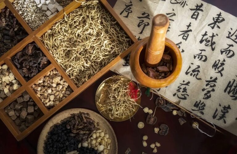 Dried Chinese medicinal roots and herbal ingredients in wooden compartments